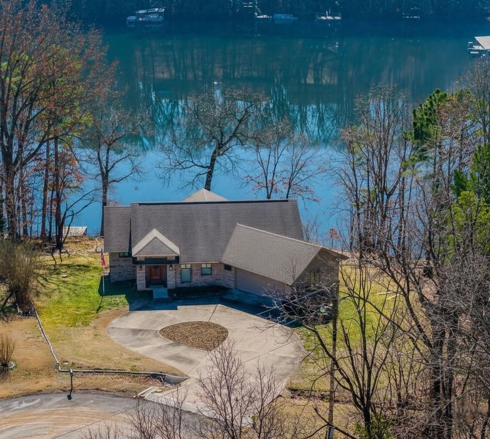 Image 1: View of front facade featuring stone siding, circu