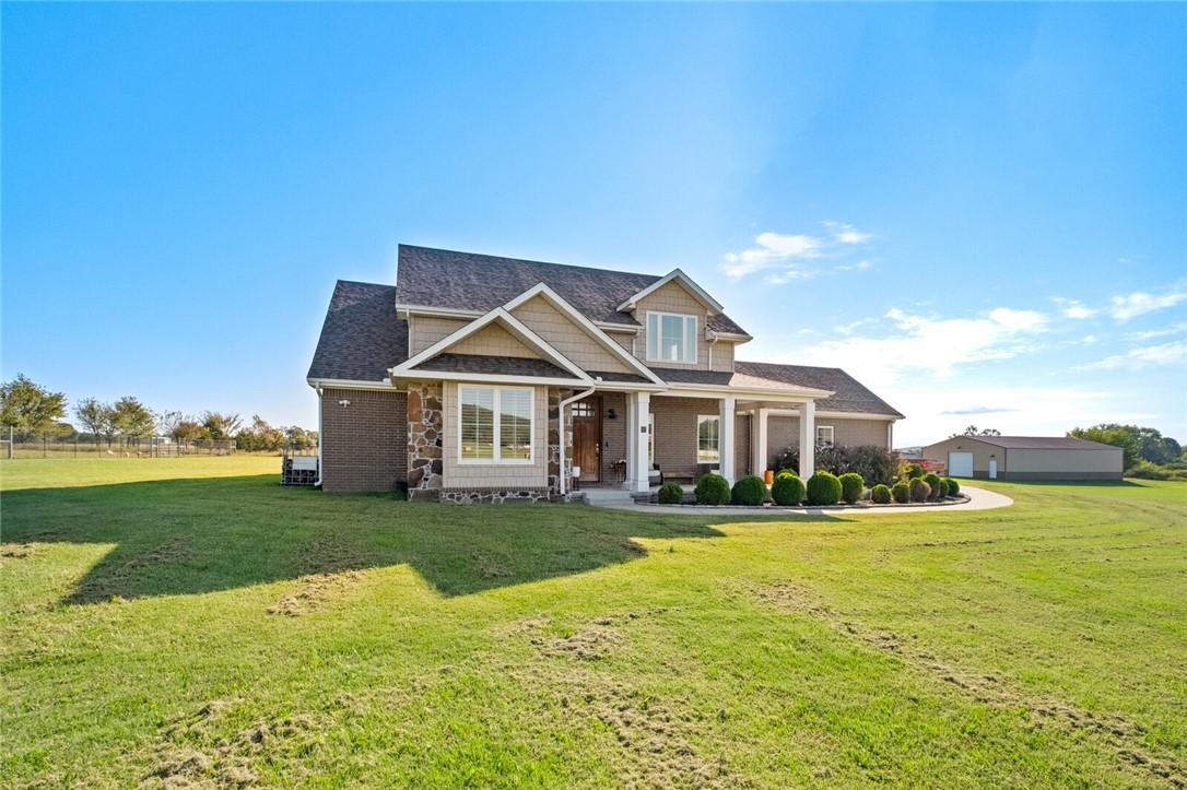 Image 3: Craftsman-style home with covered porch, a front y