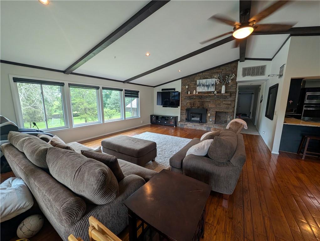 Image 2: Spacious living area featuring a vaulted ceiling w