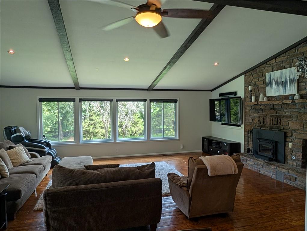 Image 3: Living area featuring a vaulted ceiling with expos