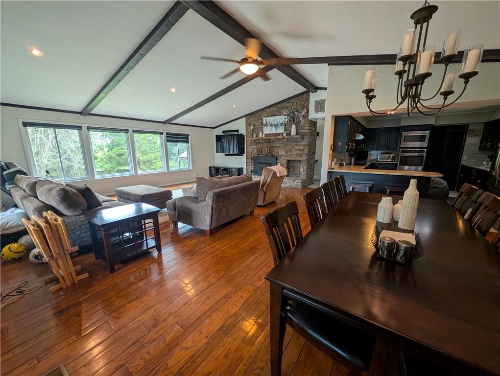 Image 4: Spacious open-concept living area featuring wood-f