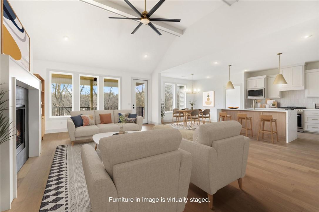 Image 2: Living area with a fireplace, light wood-type floo