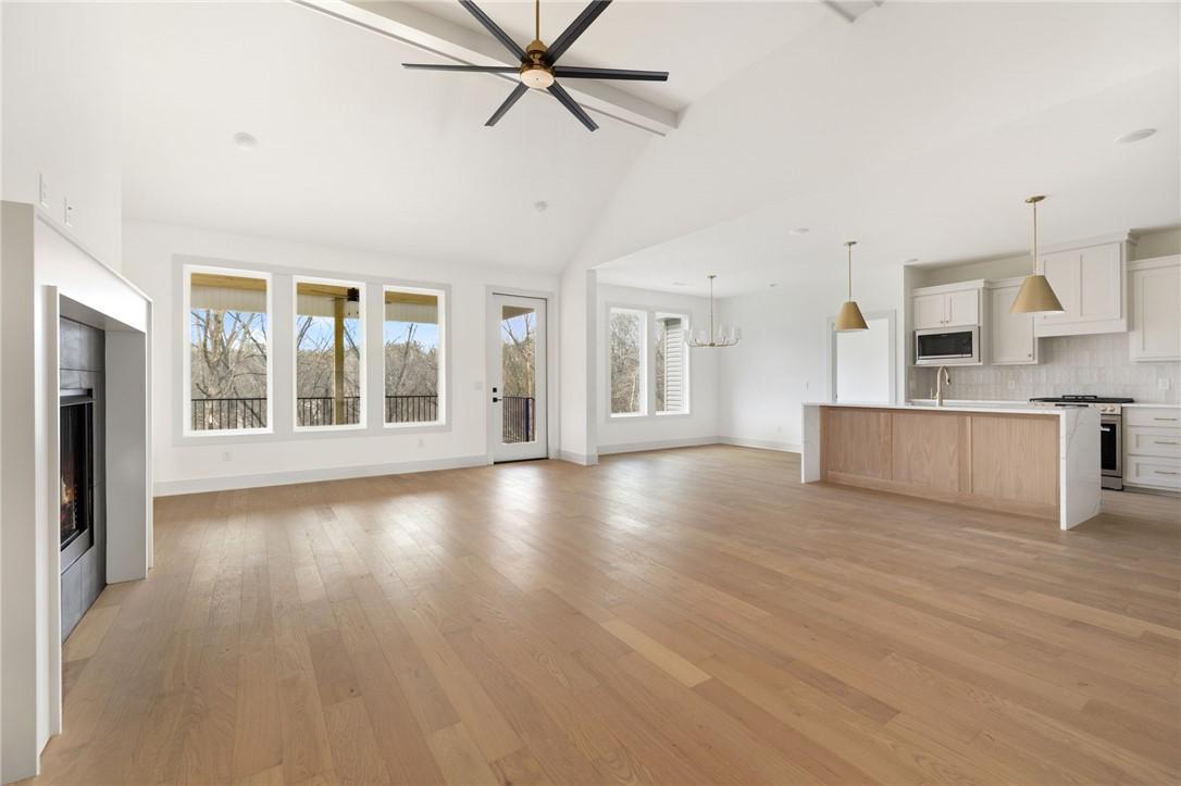 Image 3: Unfurnished living room with a fireplace, hanging