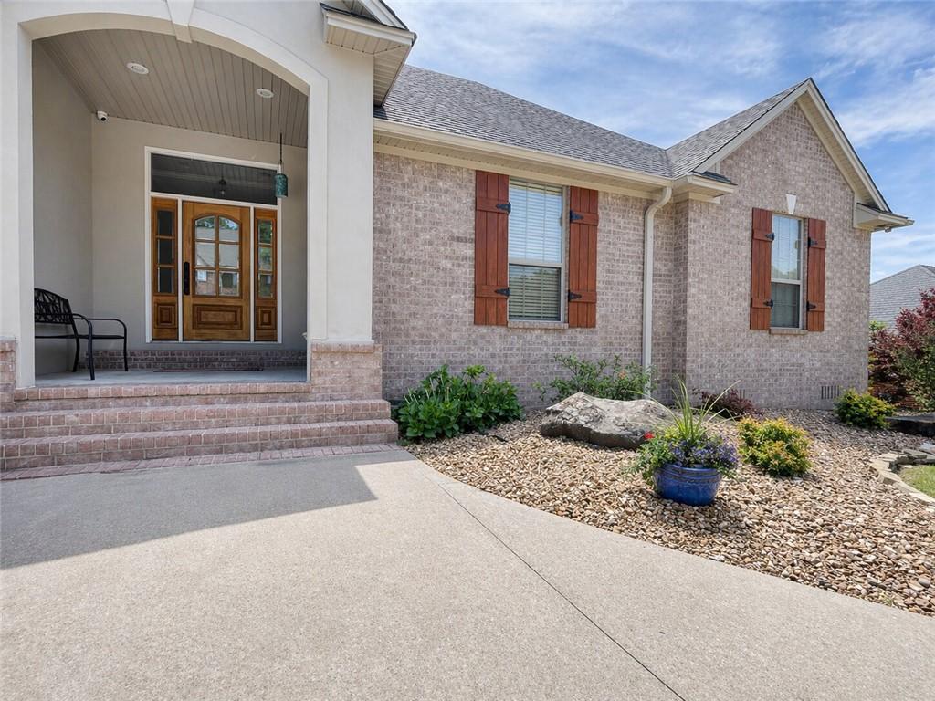 Image 4: Brick exterior with wood shutters, concrete walkwa