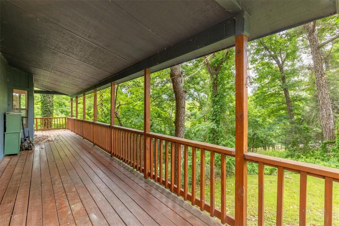Image 4: Expansive covered porch featuring wood-finish deck