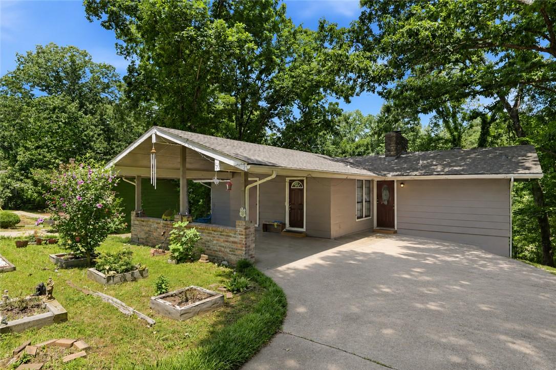 Image 3: Ranch-style exterior with a covered carport featur