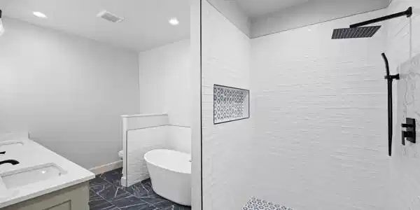 Image 2: Modern bathroom featuring a freestanding tub, dual