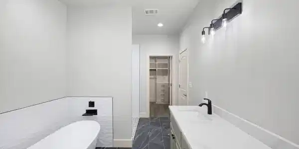 Image 3: Modern bathroom featuring a freestanding soaking t