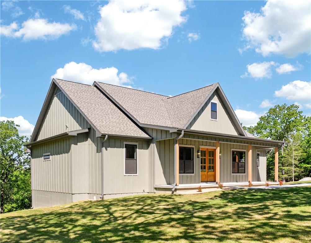 Image 2: Contemporary farmhouse exterior featuring board-an