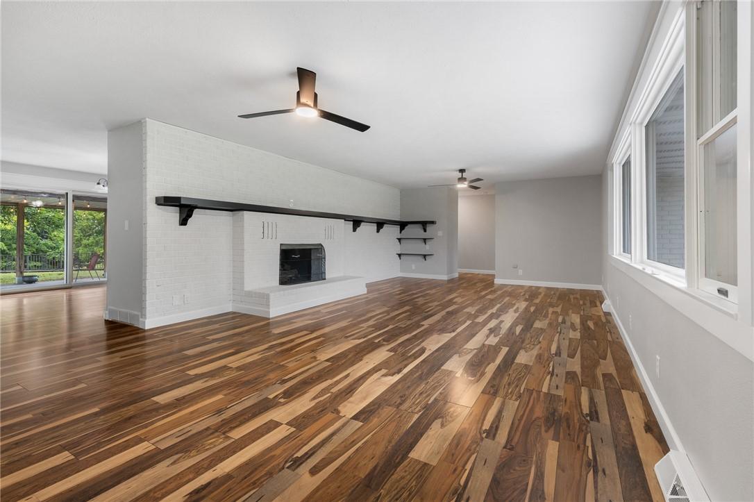 Image 4: Spacious interior featuring unique wood-finish flo