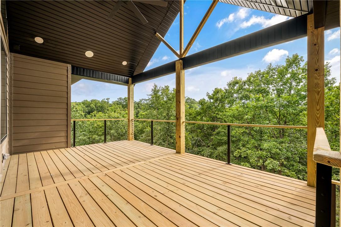 Image 3: Expansive outdoor deck featuring wood flooring, a
