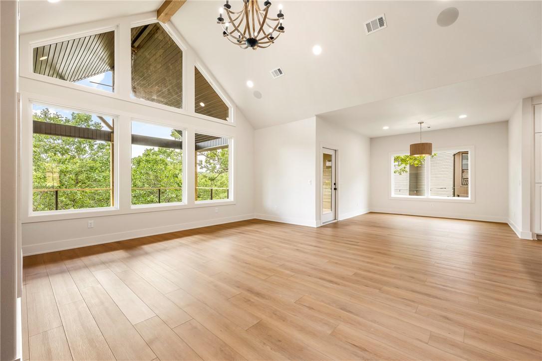 Image 4: Vaulted ceilings with exposed wood beams define th