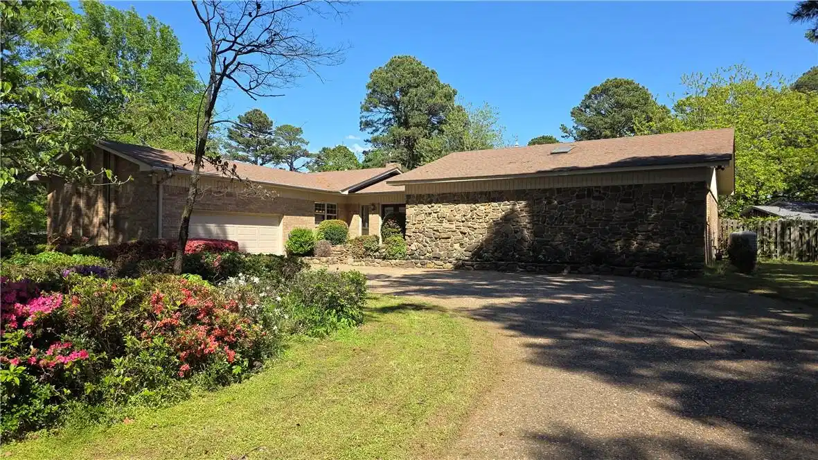 Image 1: Single story home featuring stone siding, an attac