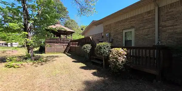 Image 3: View of yard with a wooden deck