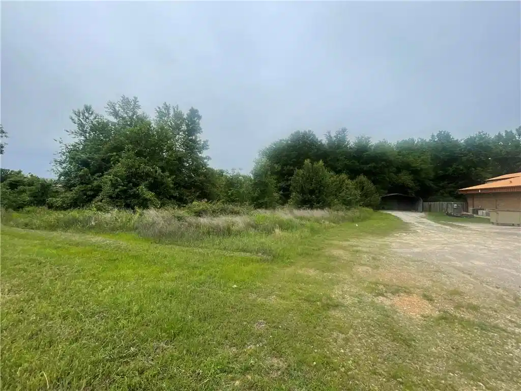Image 1: Expansive open land featuring a gravel drive, matu