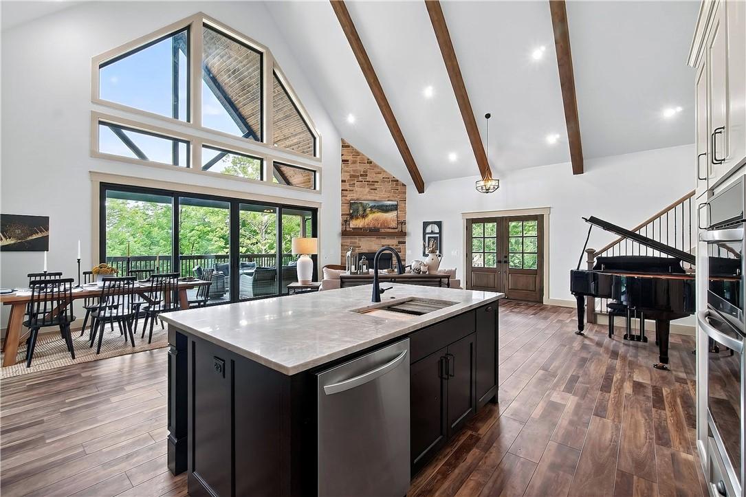 Image 3: The kitchen overlooks the living and dining area.