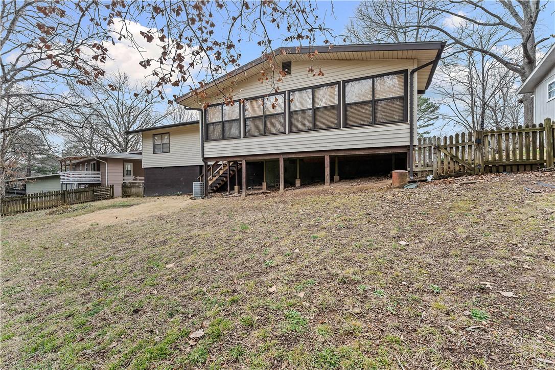 Image 1: Back of house with a sunroom and a deck