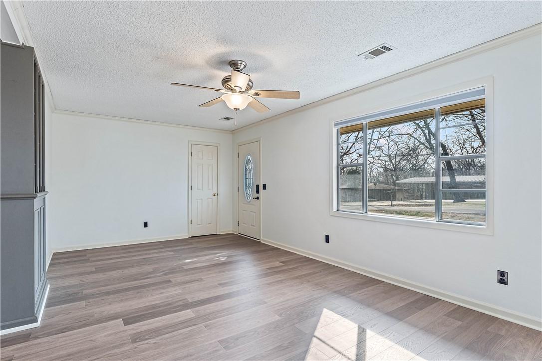 Image 4: Entryway with a ceiling fan, light wood-style floo