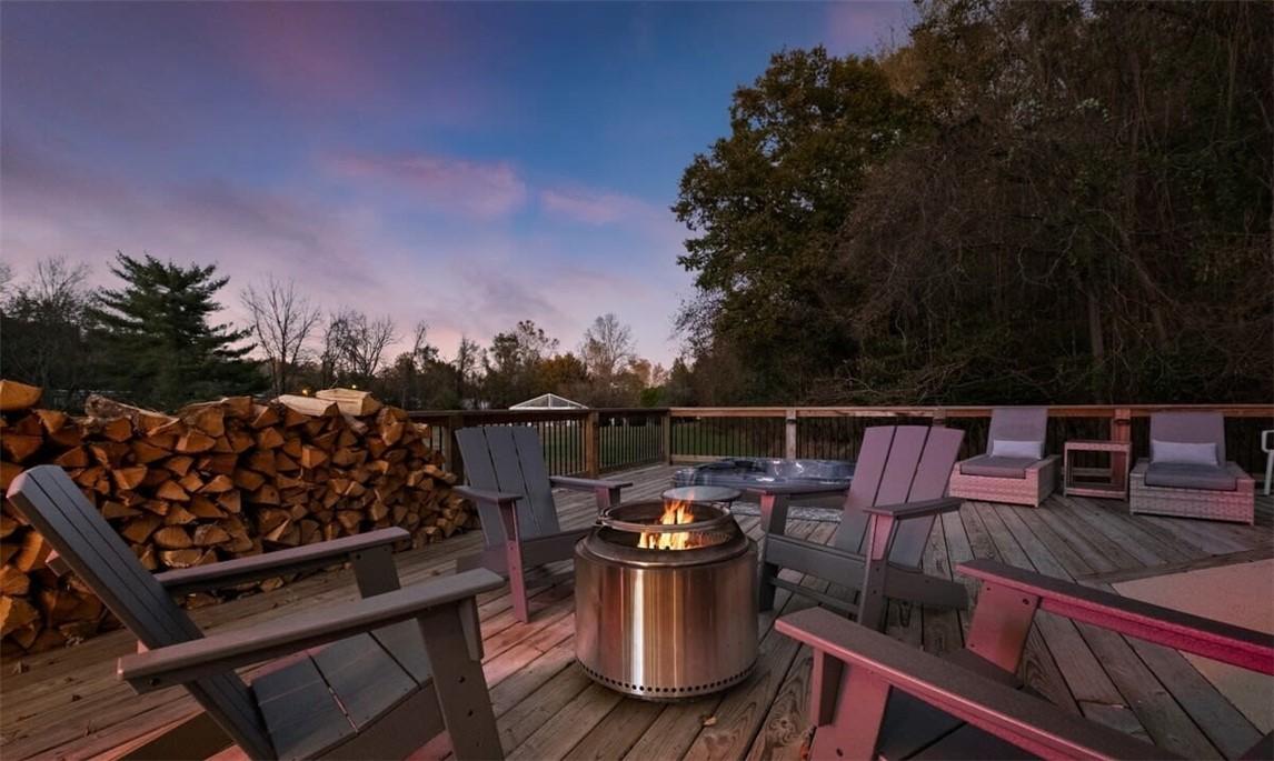 Image 4: Wooden deck with an outdoor fire pit