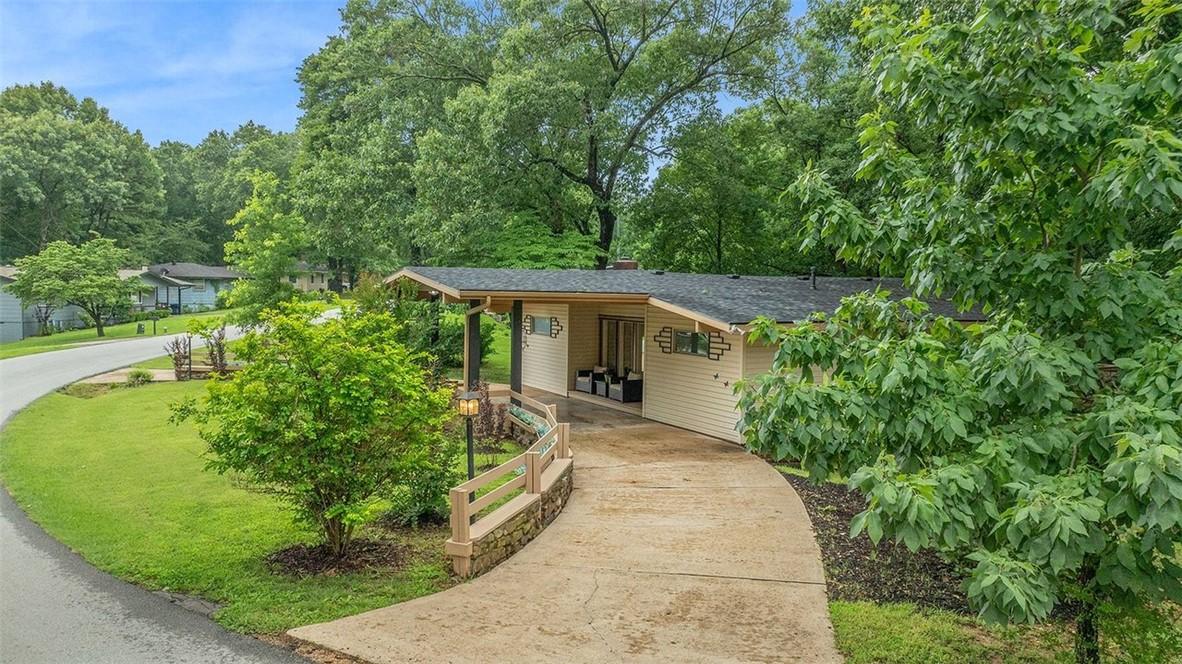 Image 1: Ranch-style residence featuring a curved concrete