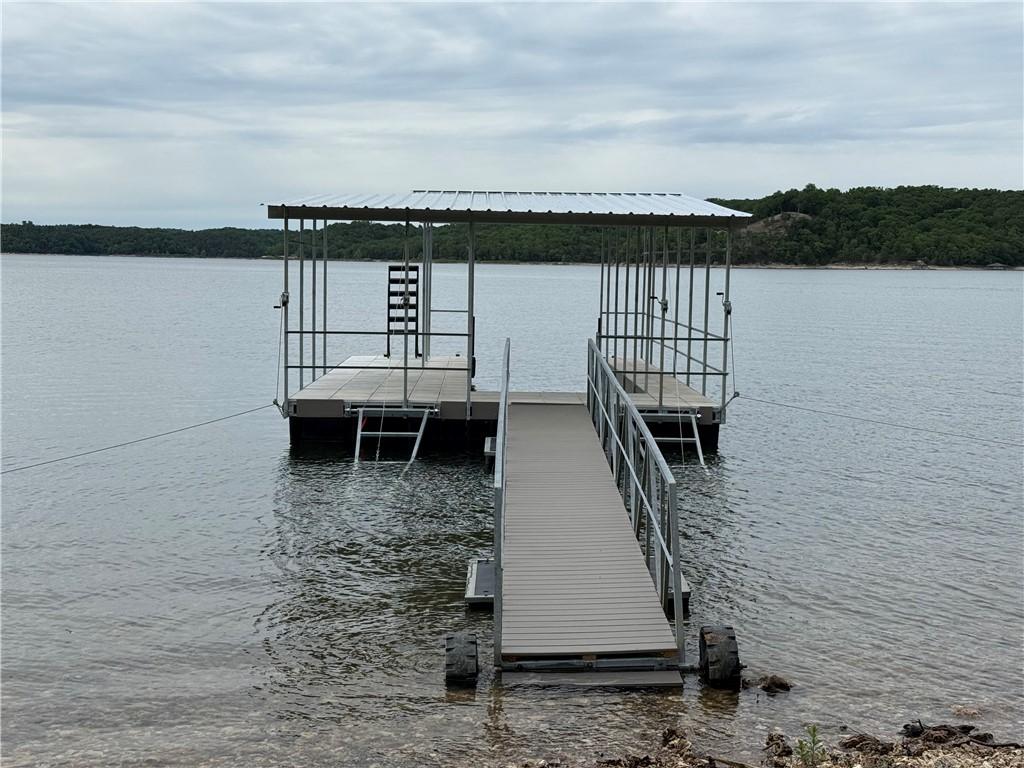 Image 2: Lakefront property featuring a private boat dock w