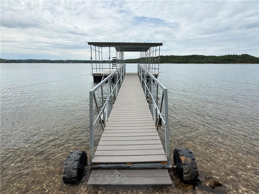 Image 3: Private boat dock featuring a covered slip and com
