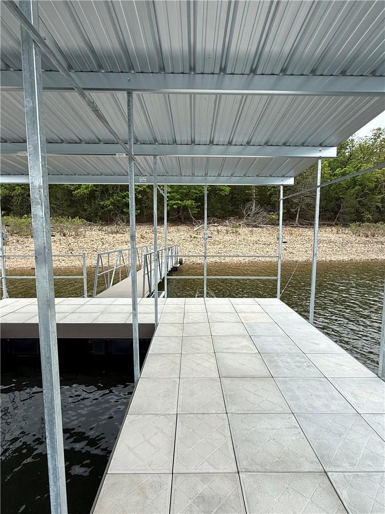 Image 4: Covered boat dock featuring a corrugated metal roo