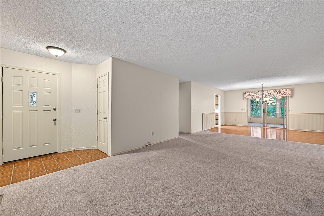 Image 2: Entry foyer with tile flooring leading to an expan