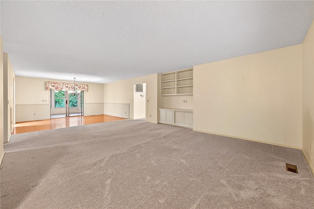 Image 4: Expansive living space featuring light-toned carpe