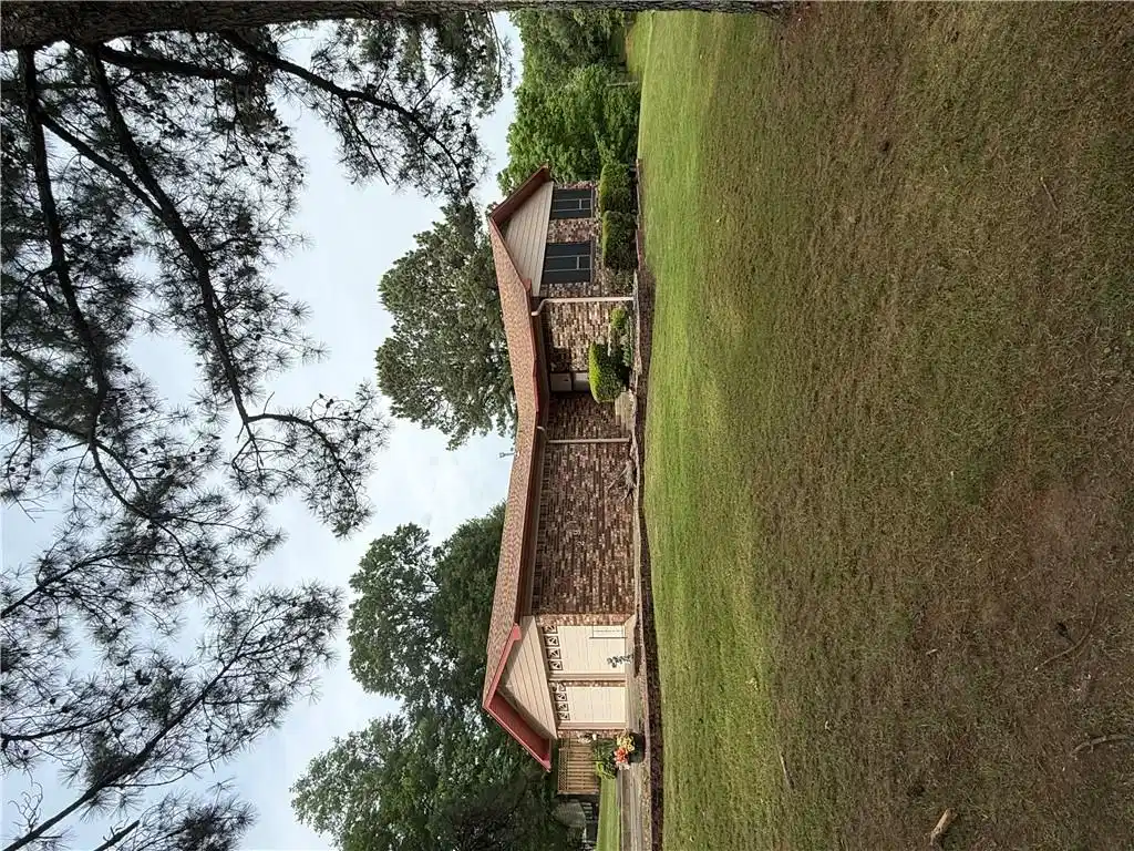 Image 1: Brick-clad residence featuring a two-car garage wi