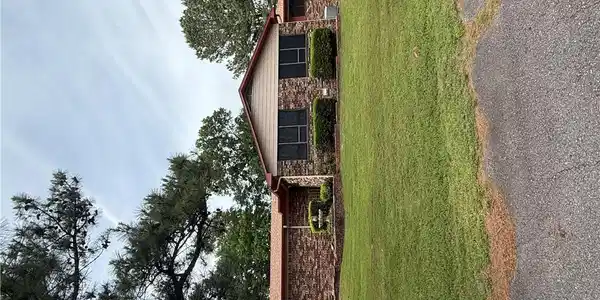 Image 2: Brick exterior with an asphalt shingle roof