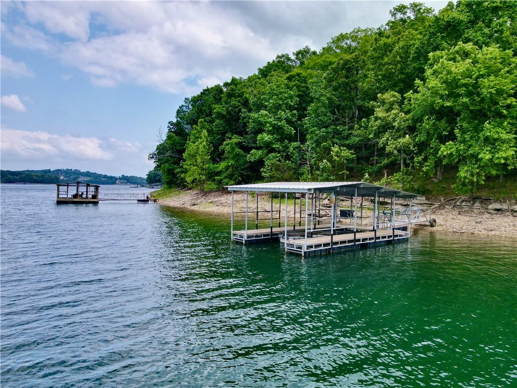 Image 1: Private boat dock with two covered slips, featurin