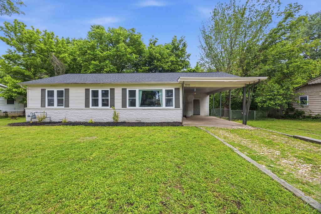 Image 1: Ranch-style exterior featuring a carport, horizont