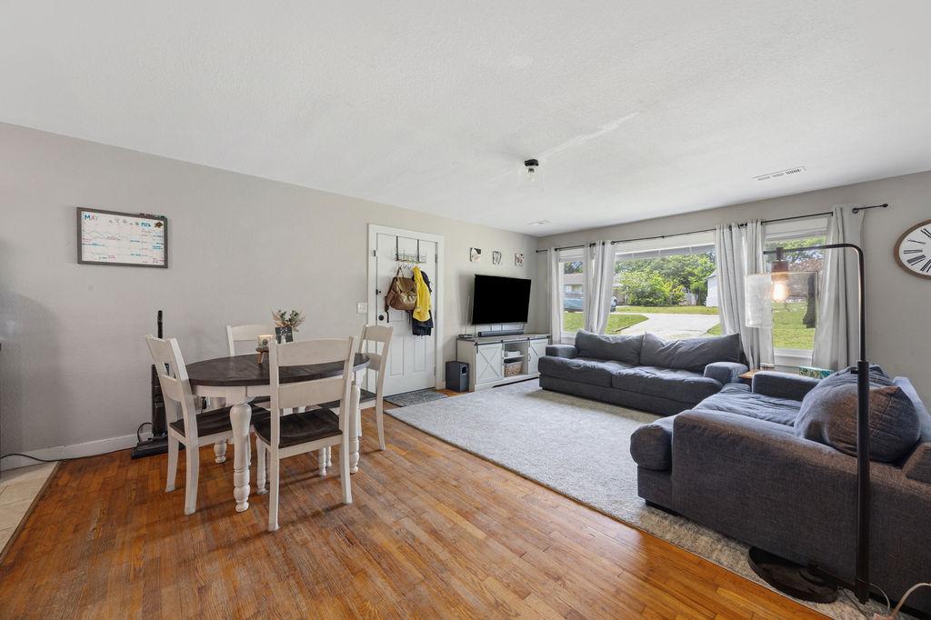 Image 4: Open-concept living area with wood-finish flooring