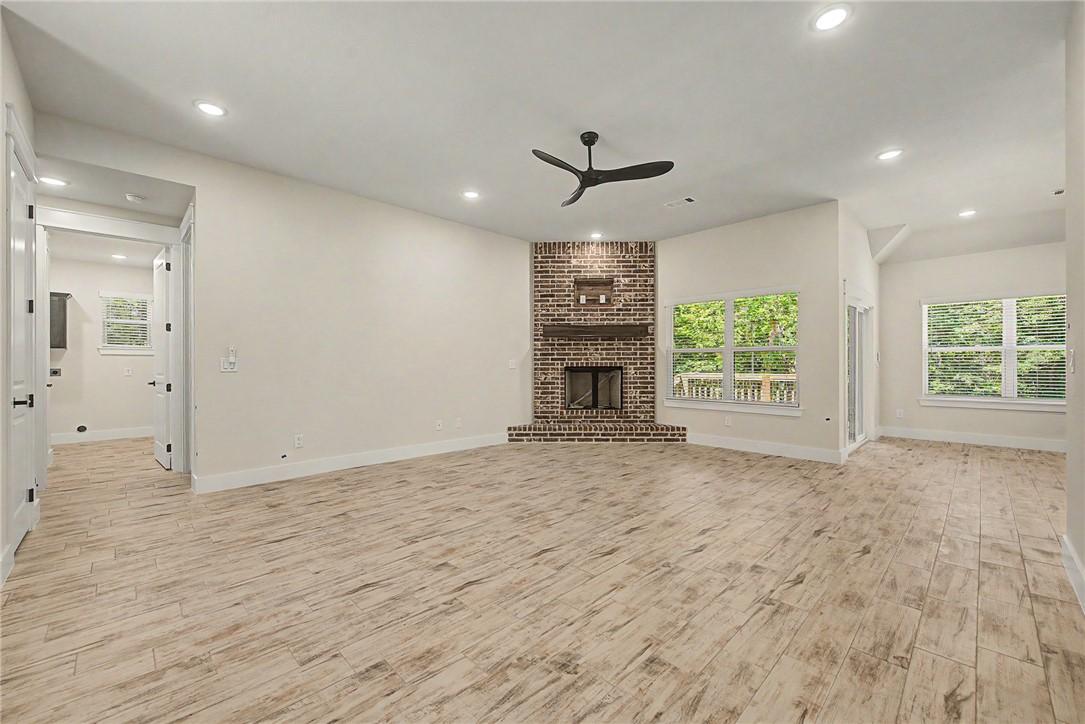 Image 4: Spacious living area featuring light wood-finish f