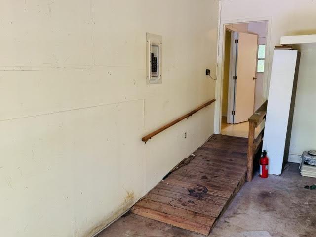 Image 4: Interior access ramp with a wooden railing and a v