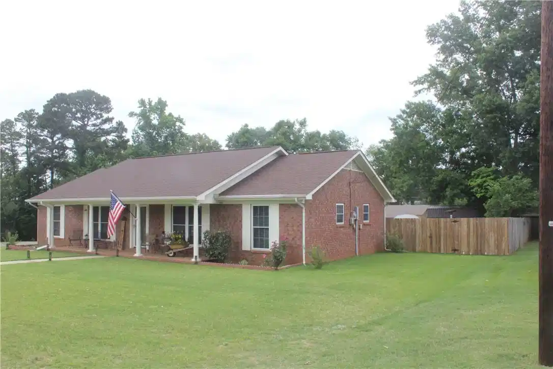 Image 1: Brick exterior home featuring a covered front porc