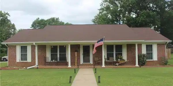 Image 2: Brick exterior featuring a covered front porch wit