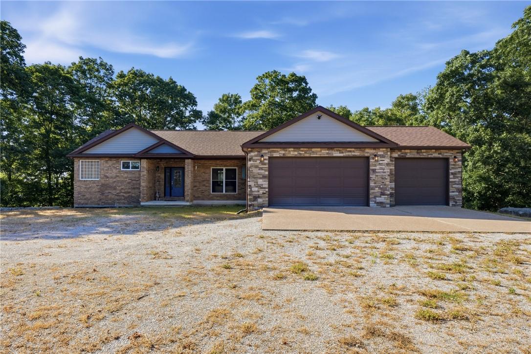 Image 2: Brick and Stone residence featuring a multi-car ga
