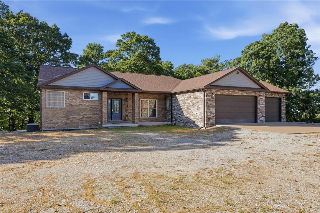 Image 3: Ranch-style residence featuring a brick and stone