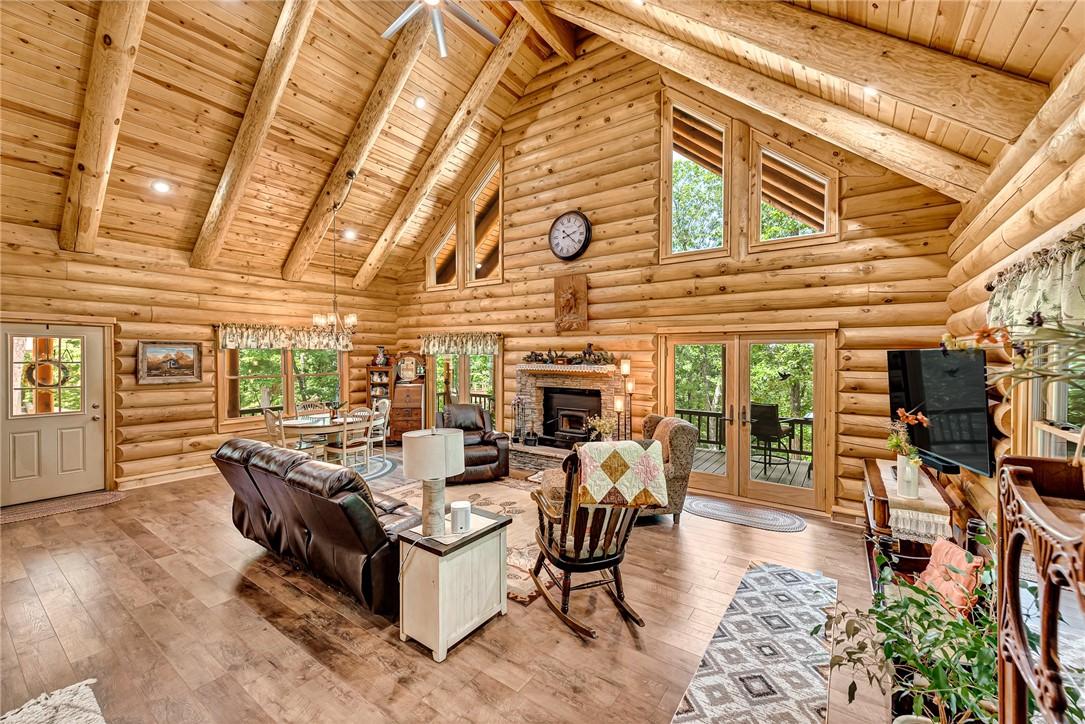 Image 3: Living area featuring high vaulted ceiling, a wood