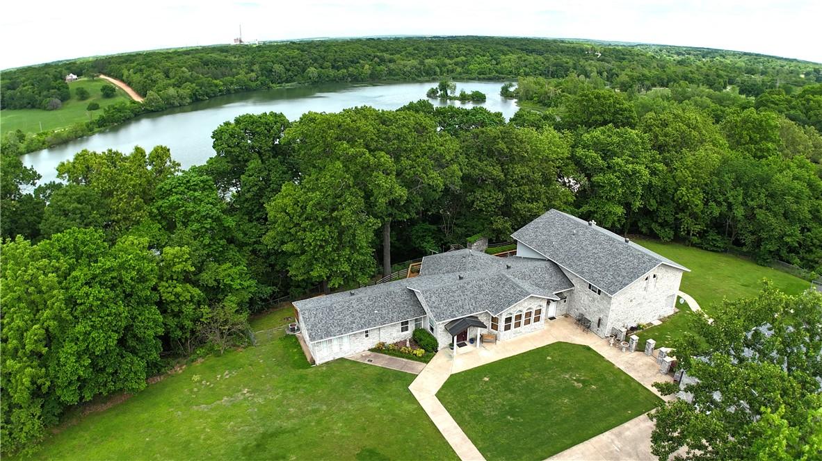 Image 3: Front view of home with lake behind.  There is a l