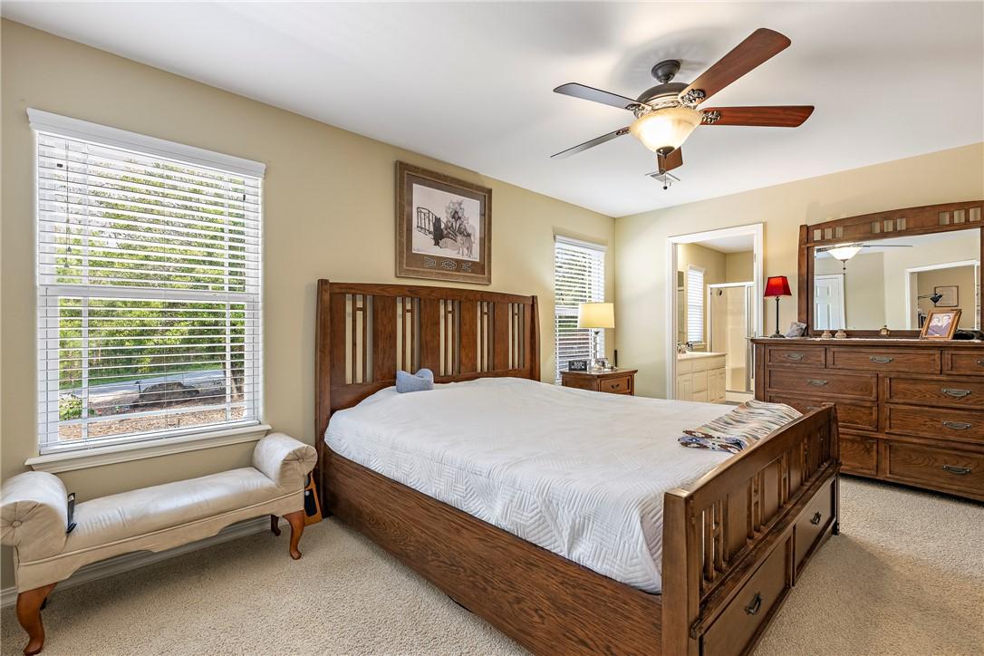 Image 3: Carpeted bedroom featuring a ceiling fan with inte