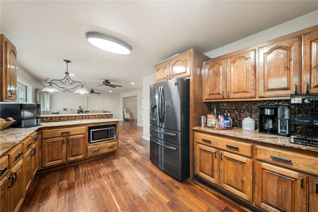 Image 4: Kitchen featuring wood-finish flooring, wood cabin