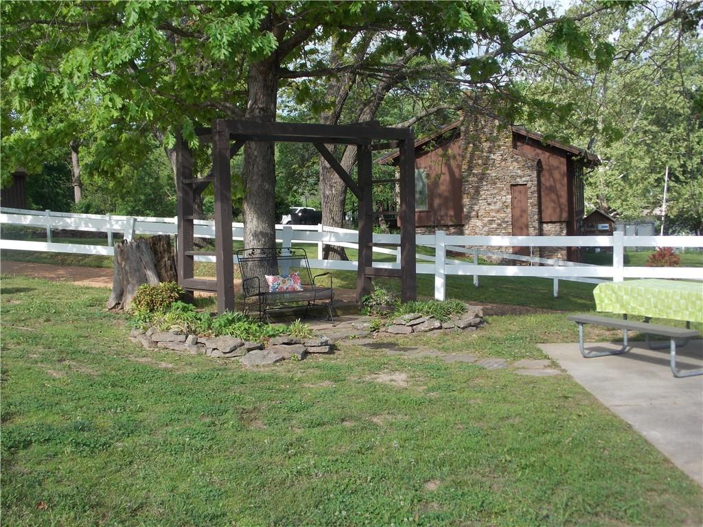 Image 2: Outdoor seating area beneath a mature tree, featur