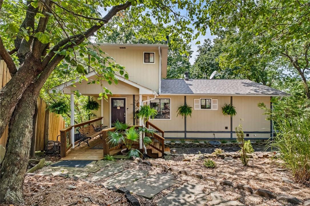 Image 2: Front of home features a carefree landscape with l