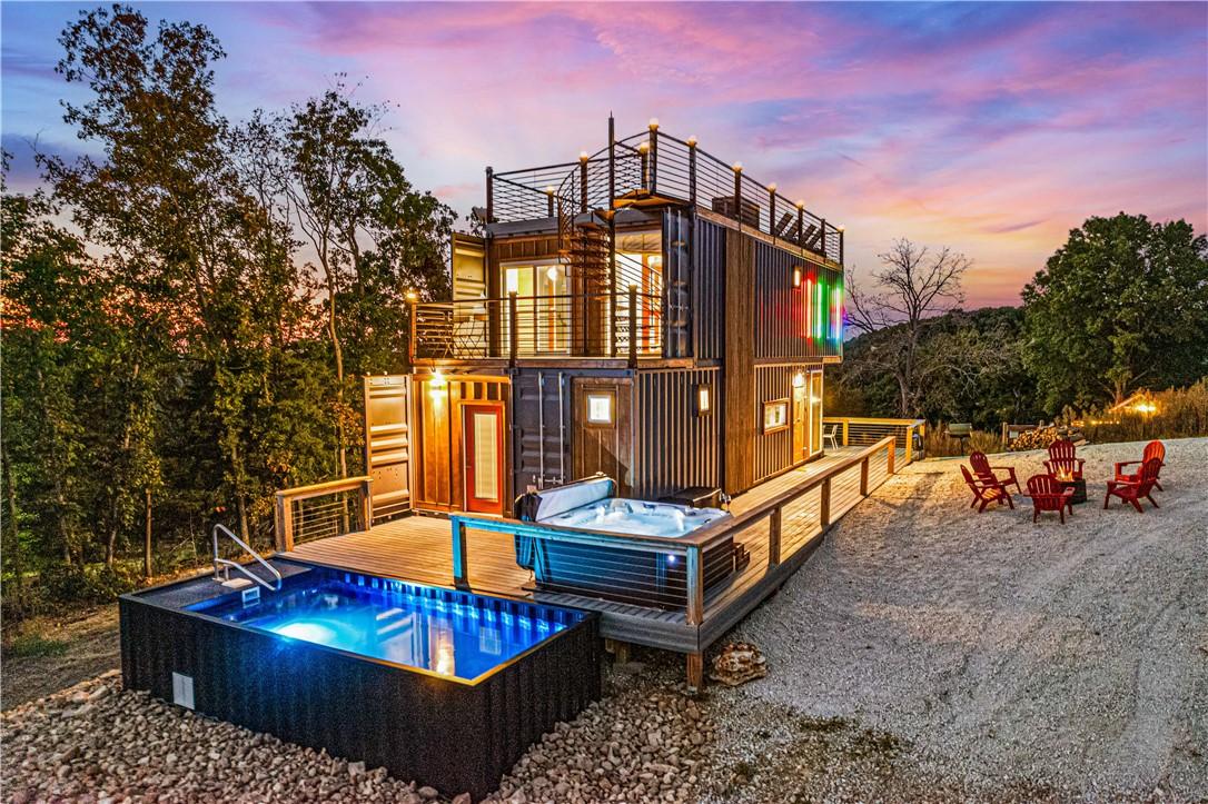 Image 1: Multi-level container home featuring a ground-leve