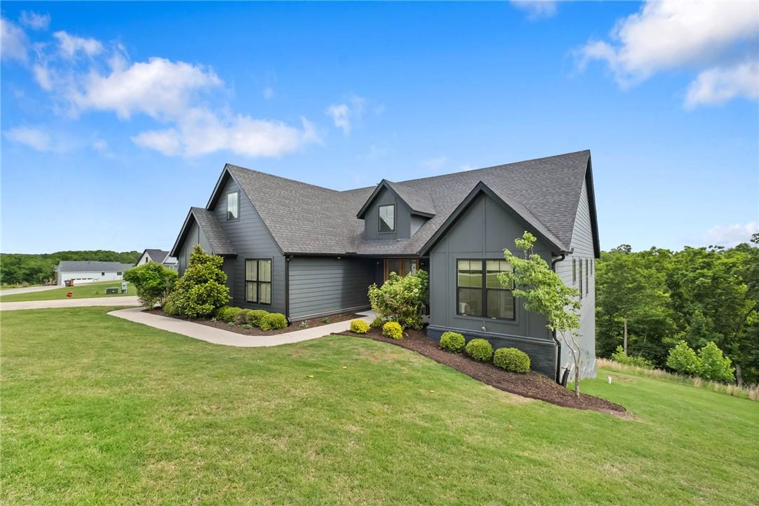 Image 3: Contemporary residence featuring dark siding, mult