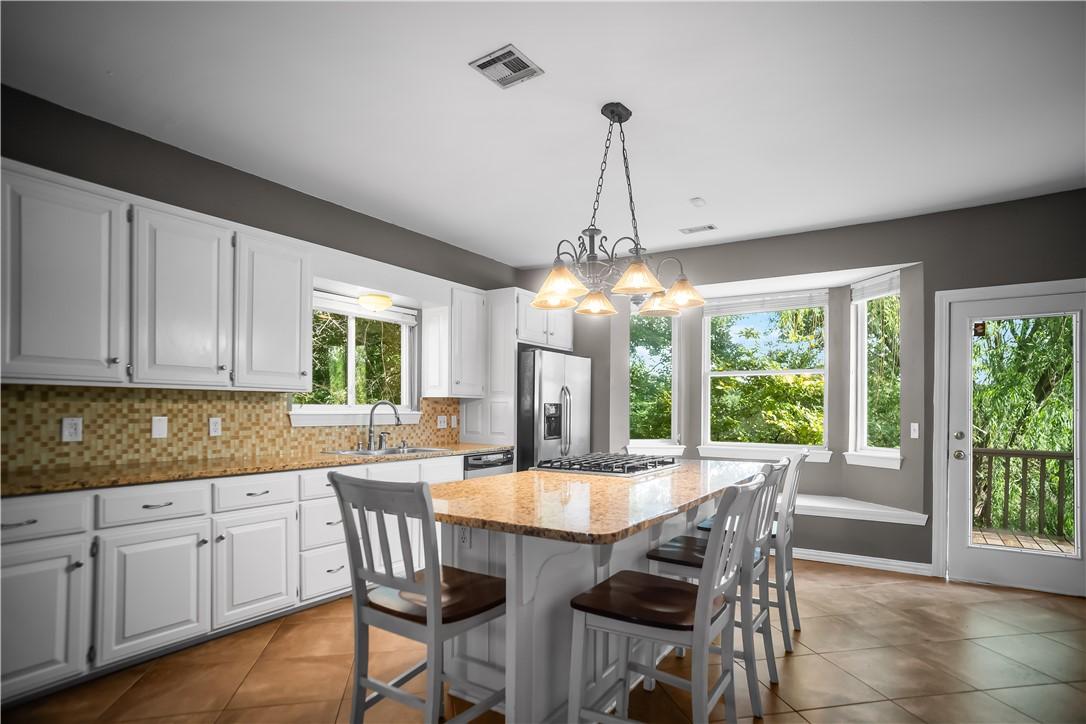 Image 3: Kitchen featuring an island with a gas cooktop, wh