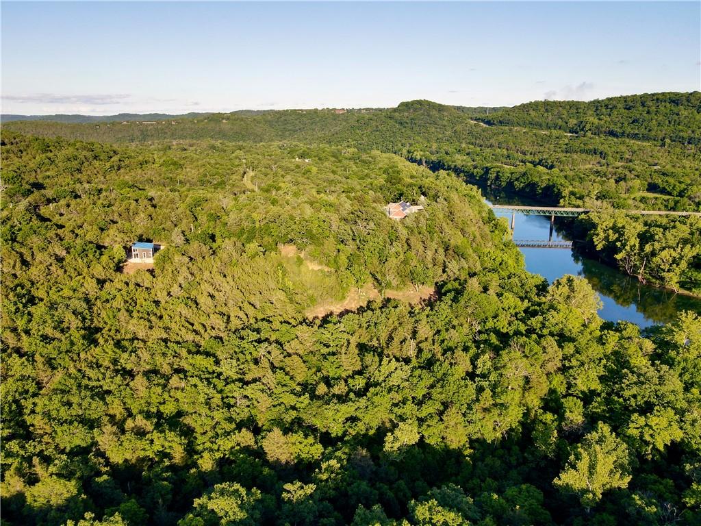 Image 1: Expansive wooded terrain featuring a prominent riv